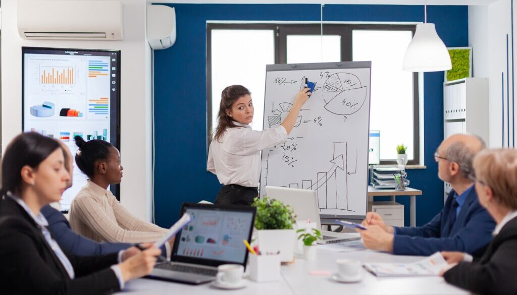 Company advisor making presentation using charts to staff